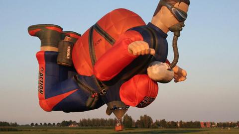 Action Man shaped hot air balloon in the sky