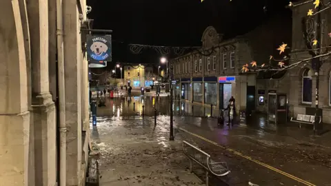 A large puddle is seen outside a Tesco Express on Chippenham's pedestrianised high street