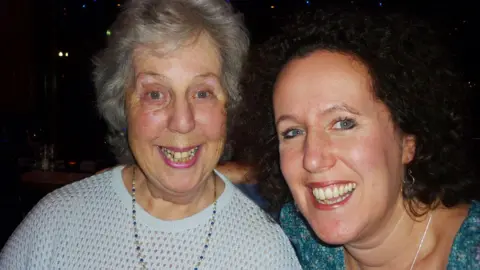 Jenny Harris Vivian and Jenny Harris smile together at a bar