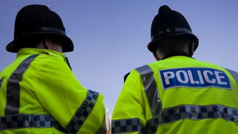 Getty Images Two police officers wearing their jackets and helmets