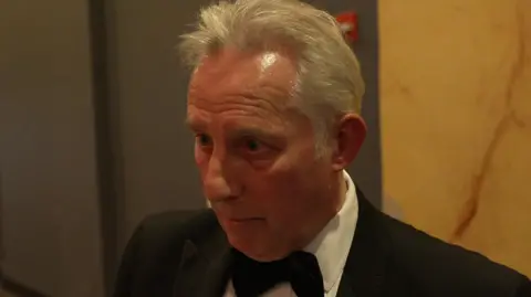 Ian Paisley in a tux. He has grey hair.