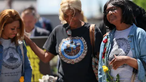 Family members of George Floyd comfort each other during a memorial 