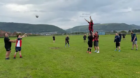 Jak throwing the ball for the line-out at a Port Talbot Panthers training session. Another player is lifted from the line-out to catch the ball.