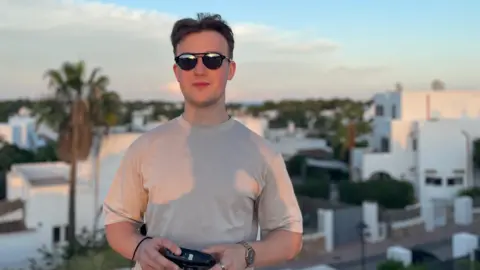 Thomas Ashley Thomas Ashley holding a camera 