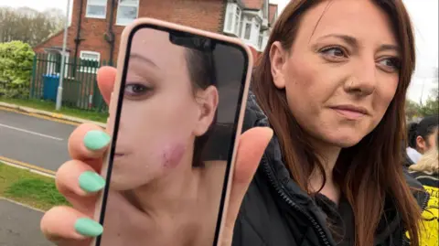 BBC Naomi Garmston holding a mobile phone