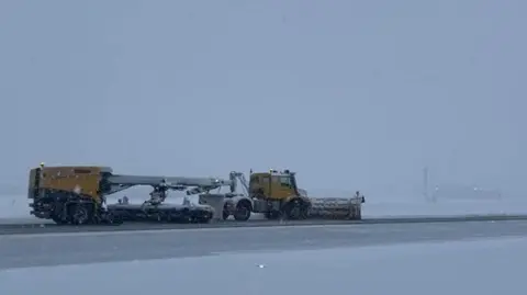 Aberdeen International Airport Snowplough crews trying to keep the snow-covered Aberdeen runway open.