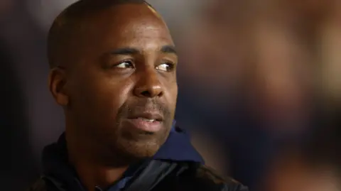 Darren Byfield looks on from the touchline during a game