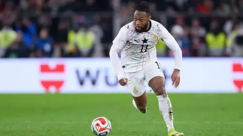 Antoine Semenyo runs with the ball in a white Ghana strip