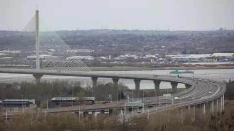 The Mersey Gateway Bridge in Runcorn is a long bridge supported by concrete pillars and steel cables