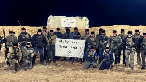 Facebook A group photo of men in military style uniforms and guns with black bars concealing their faces, standing against a desert background. They are holding a sign with Josh Millar's company logo and the slogan "Make Gaza Great Again" while behind them is a similar sign saying "FOB Mar-a-Lago", a reference to the military term Forward Operation Base and President Trump's Florida home.