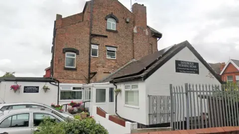 Sandrock Nursing Home, a whitewashed bungalow style building connected to a large three storey property