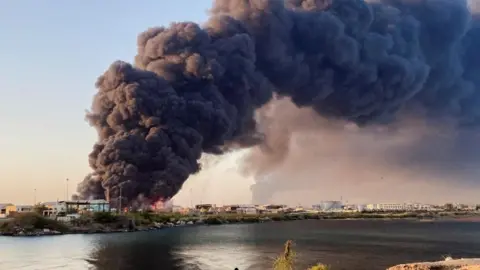 A large plume of smoke rising from fuel depot in Port Sudan