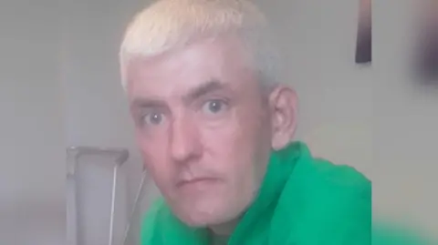 Police Scotland Michael Lincoln, a man with short, cropped white/blond hair and wearing a green top