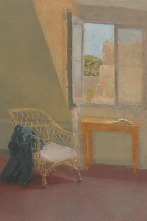 Museum Wales Oil painting of an attic room in Paris. The window is open with a wooden table underneath, which has an open book on it, and a cane lattice chair to the side of the table facing partly sideways. A greenish coat or robe hangs over one arm. A number of roofs can be seen through the window. The sky is blue and a warm pinkish light reflects off the side of the wall next to the open window.