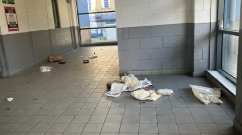 LDRS The inside of a building showing rubbish on the floor. 