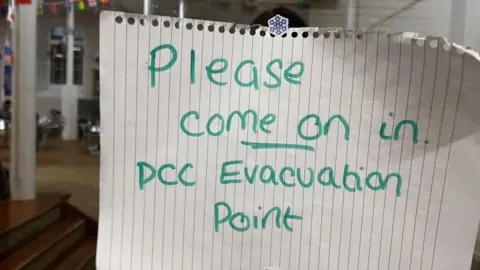 A sign on the door of the evacuation point
