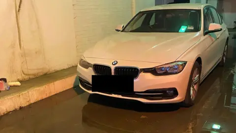 BMW car in flooded basement