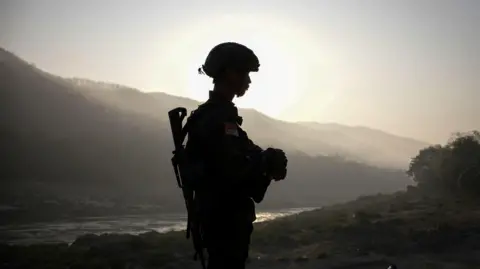 Reuters A member of Bamar People's Liberation Army (BPLA) stands guard in territory belonging to the Karen National Liberation Army (KNLA), in Karen State, Myanmar, February 18, 2024.