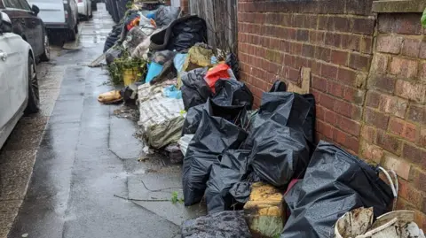 Supplied Fly-tipping along a residential road in Luton