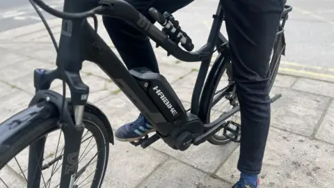 PA Media Man on an e-bike