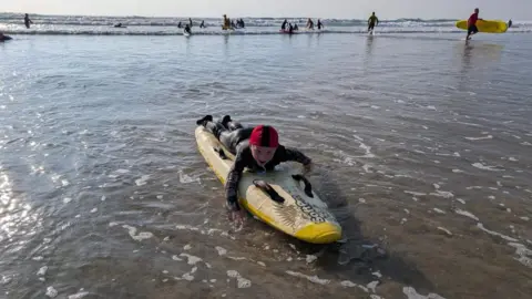 Carlyon Bay Surf Life Saving Club A boy on a board comes into shore.