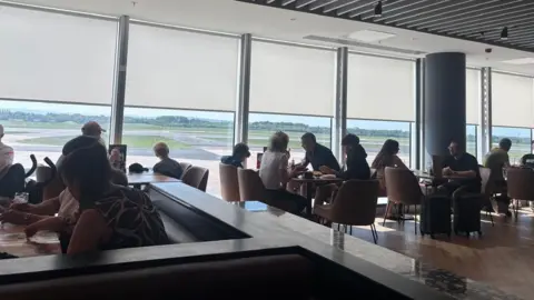 People in the departure lounge at Manchester Airport