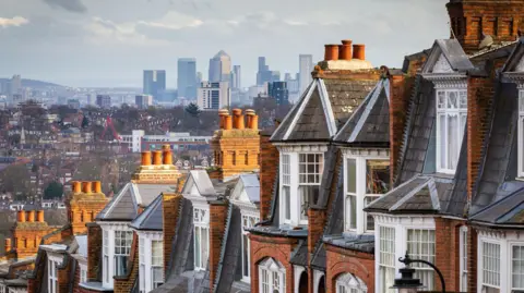 View of houses with London skyline in the distance 