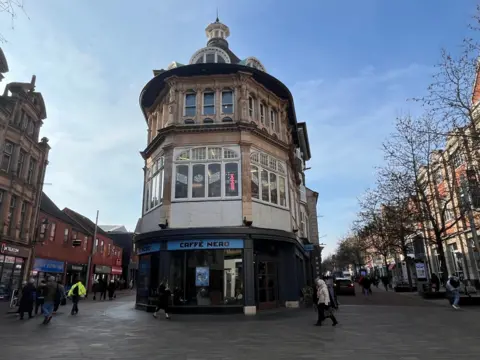 A three-storey Victorian building at the end of Leicester's High Street