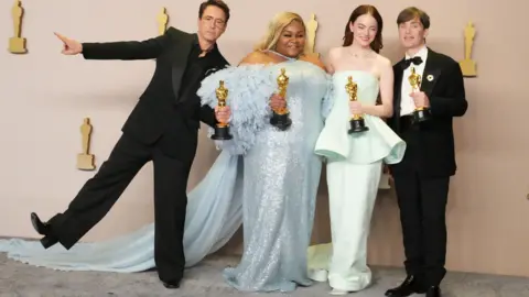 Getty Images Robert Downey Jr, Da'Vine Joy Randolph, Emma Stone and Cillian Murphy together at last year's Oscars in evening dress