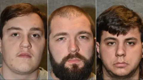 Three men staring straight ahead. One has short, dark hair while a second man has short, balding, dark hair with a dark beard. The third man has dark hair with some facial hair.