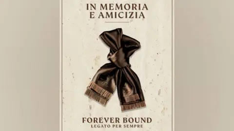 LFC An image of a bronze coloured scarf tied in a loose knot against a cream background. Text above the scarf reads "In memoria e amicizia". Text below the image reads "Forever bound. Legato per sempre".