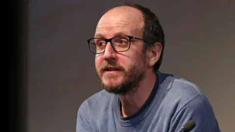 Getty Images Jack Thorne at the Best Interests BFI preview and Q&A at BFI Southbank in London in May. He has a beard and is wearing a light blue jumper.
