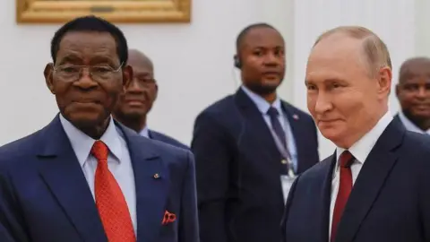 Russia's President Vladimir Putin shakes hands with Equatorial Guinea's President Teodoro Obiang Nguema Mbasogo at the Kremlin in Moscow