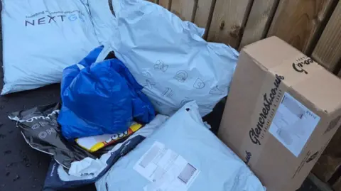 Assorted parcels lying next to a fence
