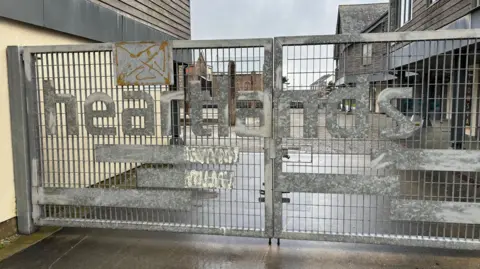 A picture of the gates of the front entrance to Heartlands.