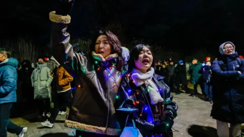 People gather in the capital Seoul to protest against South Korean President Yoon Seok-yeol as National Assembly members vote on impeachment. 