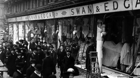 Hulton Archive/Getty Images A crown outside a department store, Swan and Edgar, with smashed windows