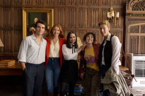 Netflix Esme stood around the leading cast of the movie in a shot that is featured in the film