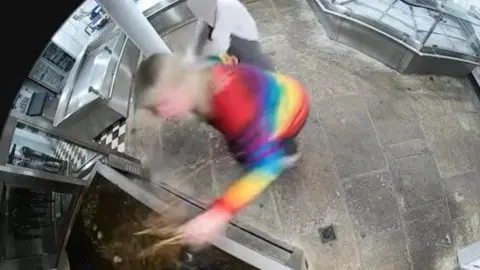 Woman snatching a crayfish from a tank