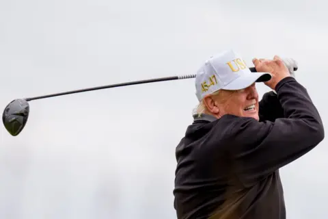 President Donald Trump, President Donald Trump, is raising a new 18 -hole in Trump International Golf links in Batti, near Aberdeen. He wears the Pissam Car