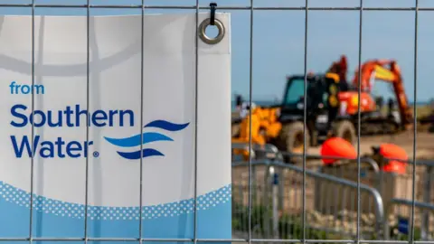 Getty Images Security fencing and public information posters near the preparations for the laying of a new outfall pipe from at Swalecliffe wastewater treatment works, operated by Southern Water Ltd