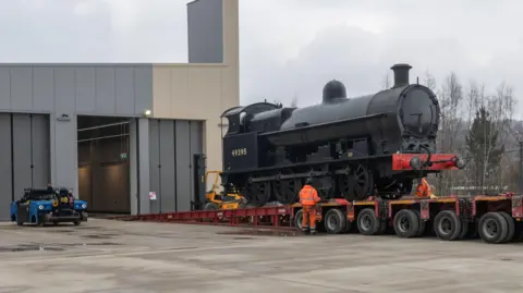Locomotion Locomotive Super D is unloaded into New Hall