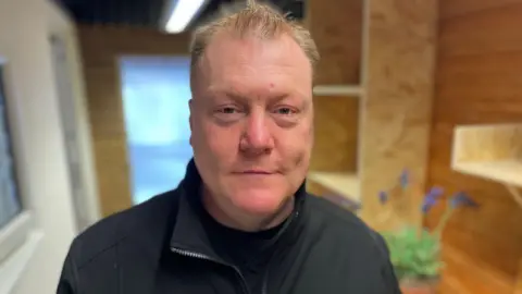 Terry is wearing a black fleece