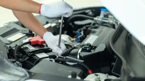 A mechanic undertaking an MOT.