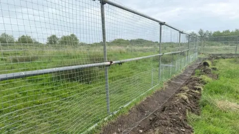 Derbyshire Wildlife Trust Fencing being installed on a green space in Willington