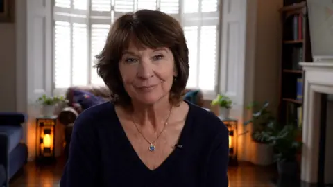 Carol Alexander sits at home during an interview