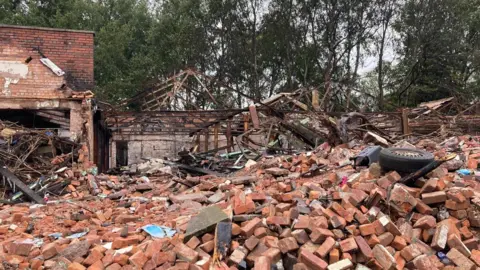 Bricks and debris from derelict buildings from greenway running parallel to rear of moat street and new hall street. 
