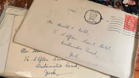 Noah Wild A pile of envelopes with addresses written in cursive handwriting