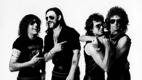 Getty Images Mick "Wurzel" Burston, Lemmy Kilmister, Phil Campbell and Pete Gill of Motörhead, in 1984