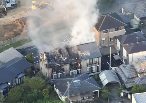 Reuters An aerial view shows a residential building on fire after an earthquake with a preliminary magnitude of 7.1 struck Japan's southern Kumamoto prefecture, in Yatsushiro, Kumamoto prefecture, Japan, July 28, 2026.